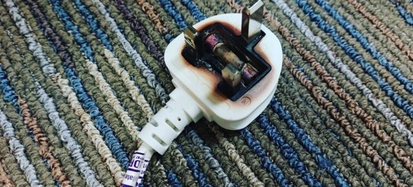 white sealed plug for electric heater that has overheated - this was PAT Tested by us just a few days before, and was fine then